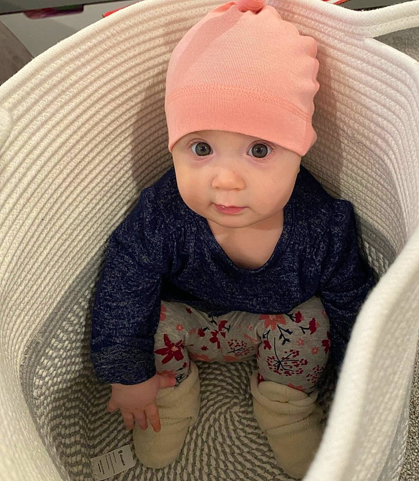 Ivy is registered to the contest to win money with this photo: baby, baby_toddler_clothing, cap, cheek, chin, clothing, comfort, face, head, headgear, headwear, human_body, knit_cap, neck, pattern, person, product, skin, sleeve, textile