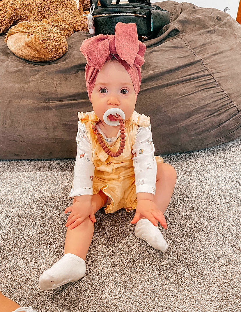Ivy joined the competition — help win amazing prizes! baby, baby_toddler_clothing, bean_bag, comfort, flooring, foot, fun, fur, happy, hat, head, mammal, orange, peach, person, sitting, sleeve, smile, surprise, textile