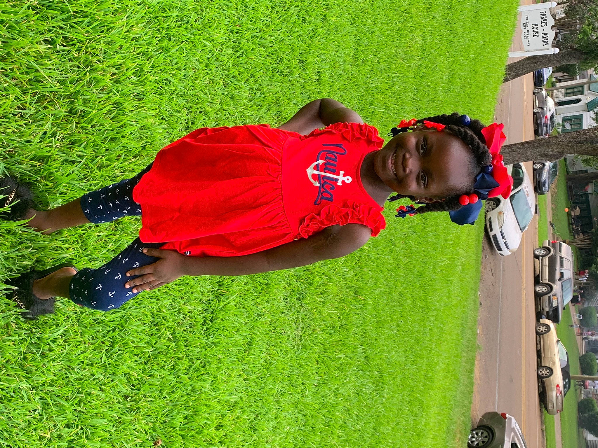 Courtney is registered to the contest to win money with this photo: artificial_turf, car, fun, grass, green, joy, lawn, leaf, leisure, people_in_nature, person, plant, recreation, shadow, shrub, t_shirt, tree, vehicle_door