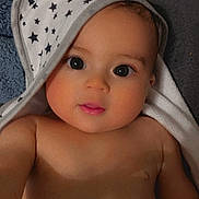 Kade is registered to the contest to win money with this photo: baby, infant, child, portrait, face, eyes, smiling, indoor, towel, hood, stars, bare_shoulders, lying_down, close_up, blanket, soft_lighting, home, cute, photography, adorable