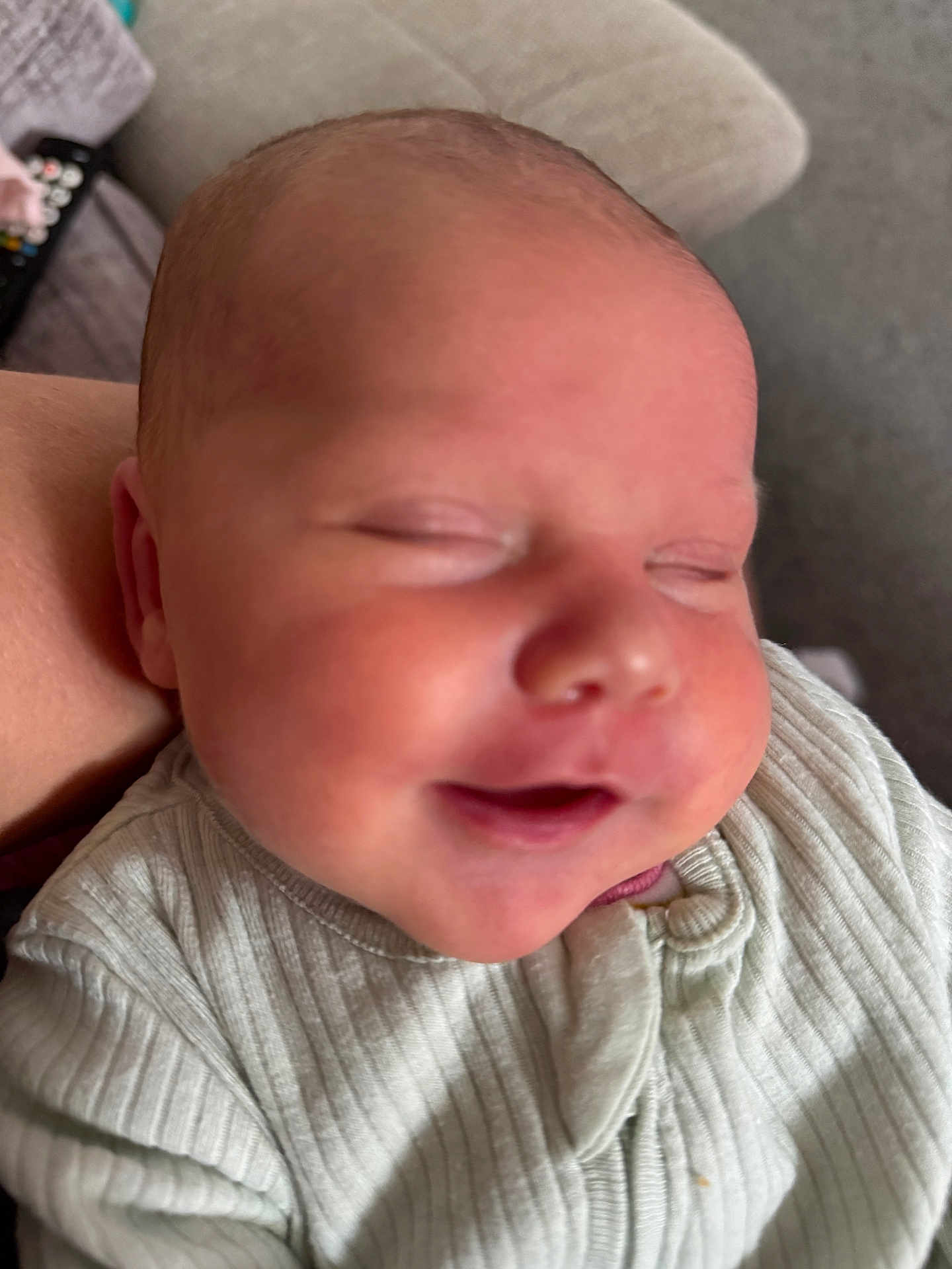 Lily-Anne is registered to the contest to win money with this photo: baby, newborn, smiling, face, closed_eyes, infant, sleeping, person, clothing, ribbed_fabric, cozy, skin, head, cheeks, indoors, human, portrait, cute, peaceful, closeup