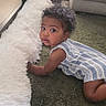 baby, child, curly_hair, carpet, rug, living_room, furniture, couch, green, white, striped_clothing, cute, toddler, indoors, floor, person, portrait, expression, curiosity, soft_texture