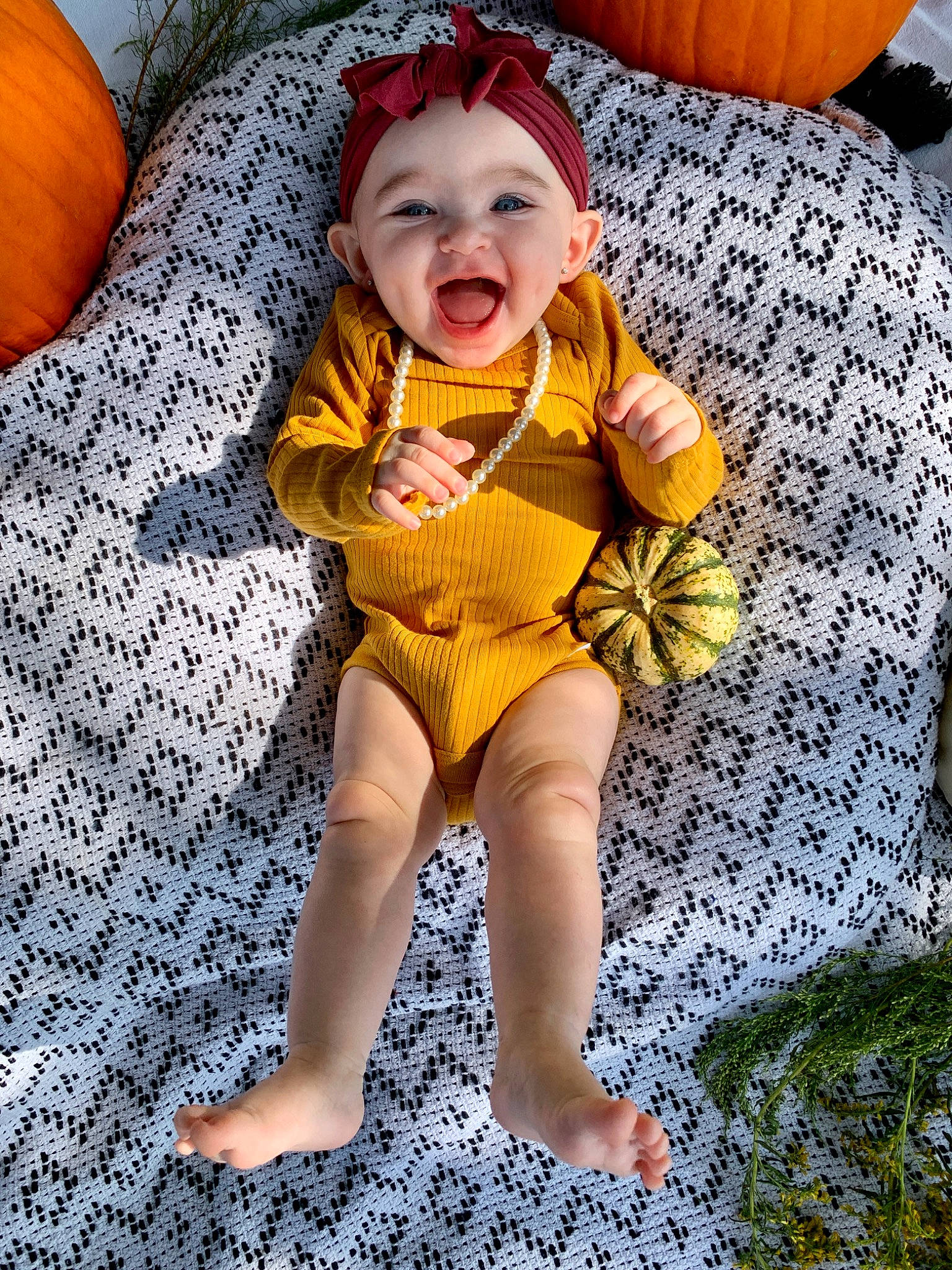 Ava Grace joined the competition — help win amazing prizes! baby, baby_toddler_clothing, child, comfort, eye, face, flooring, fun, happy, head, headwear, leg, person, plant, pumpkin, sitting, sleeve, smile, textile, thigh