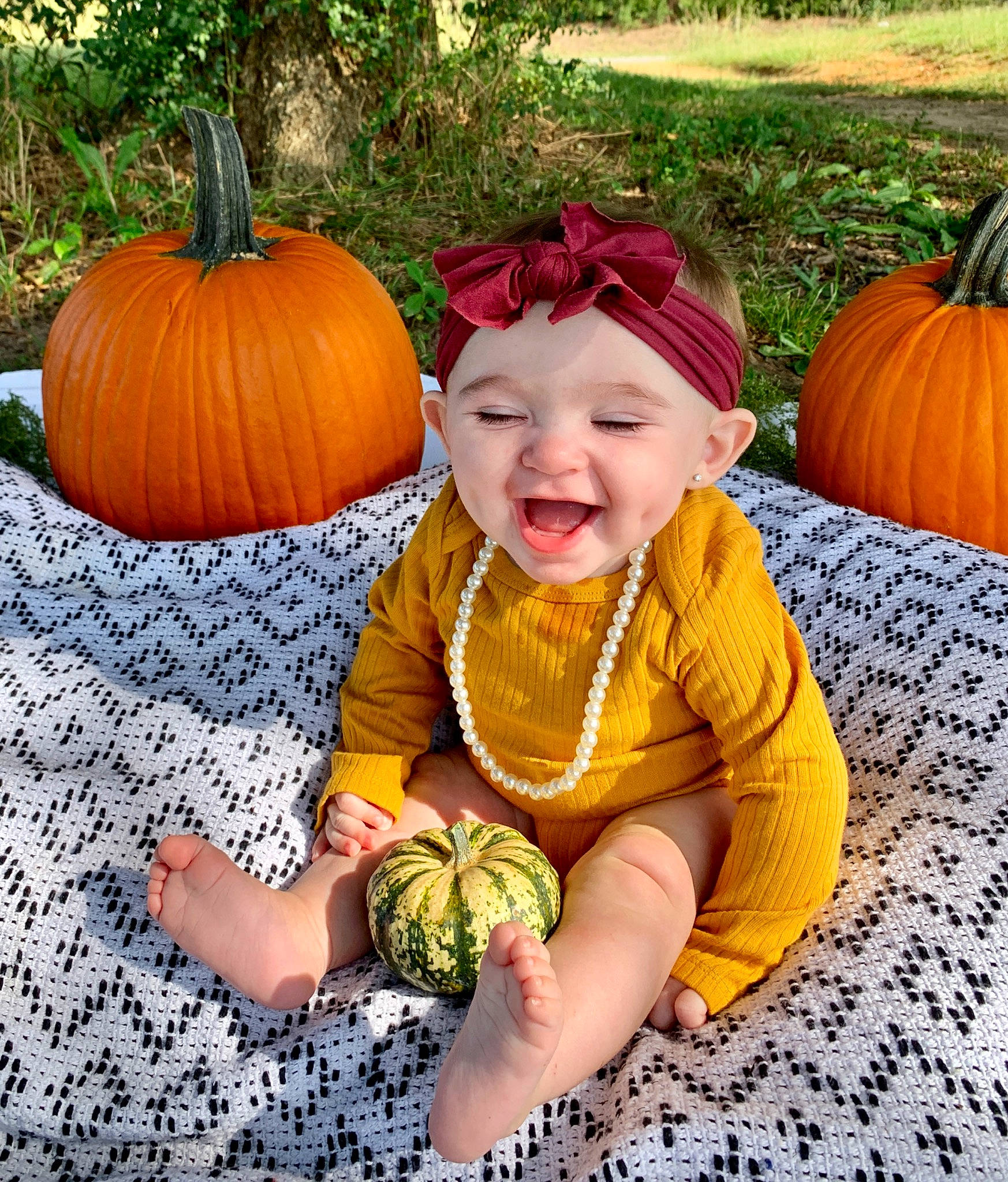 Ava Grace joined the competition — help win amazing prizes! baby_toddler_clothing, botany, calabaza, cucurbita, eye, facial_expression, grass, happy, headwear, human_body, leaf, natural_foods, nature, orange, people_in_nature, person, photograph, plant, pumpkin, smile