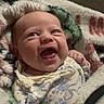 Elodie is registered to the contest to win money with this photo: baby, smile, infant, blanket, cozy, happy, cute, clothing, portrait, child, indoors, expression, wrapped, newborn, face, warm, soft, person, joy, comfort