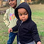 child, hoodie, outdoor, grass, casual_clothing, sneakers, smile, two_children, happy, cute, playful, nature, park, tree, portrait, person, jeans, young, fun, friends
