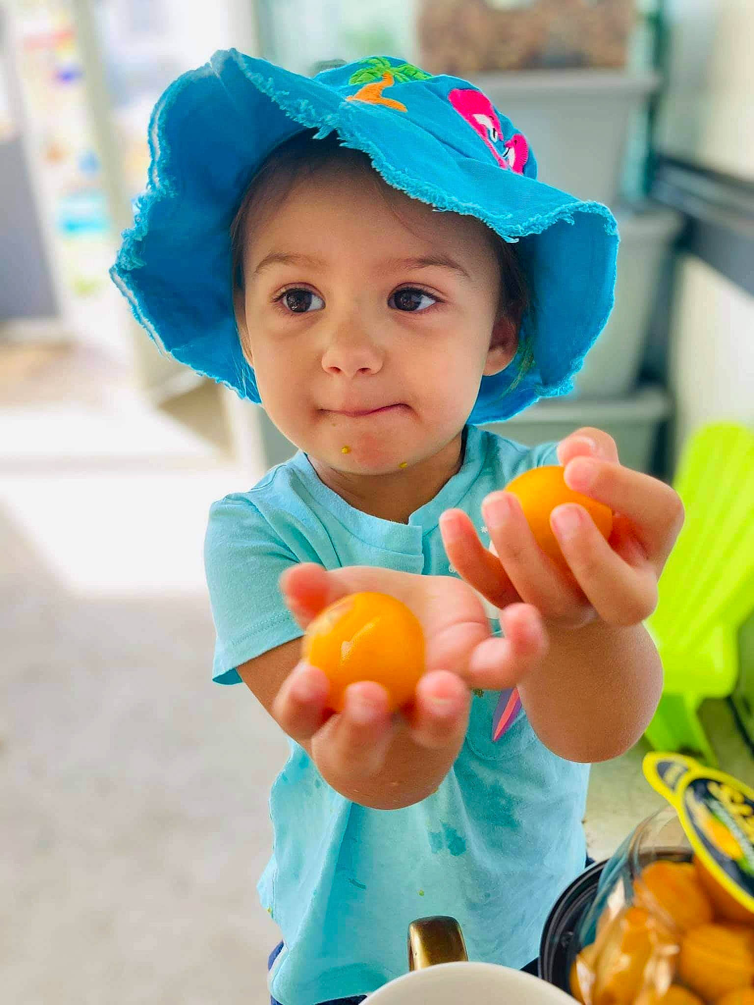 Isabelle is registered to the contest to win money with this photo: baby, beauty, child, food, headwear, person, play, skin, smile, snapshot, toddler, yellow