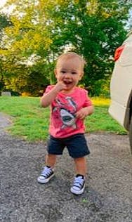 Camden is registered to the contest to win money with this photo: baby, child, finger, fun, grass, leaf, leisure, person, pink, plant, play, playground, public_space, recreation, smile, summer, thumb, toddler, tree, vacation