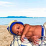 baby, infant, beach, sand, ocean, blanket, crocheted_hat, crocheted_diaper_cover, lighthouse, anchor, hand, lying_down, outdoors, sky, water, relaxing, cute, child, nautical, summer