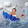 baby, infant, fabric, blue, tulle, clouds, fish, creative, imaginative, cute, portrait, soft, child, playful, props, background, lying_down, indoors, artistic, colorful