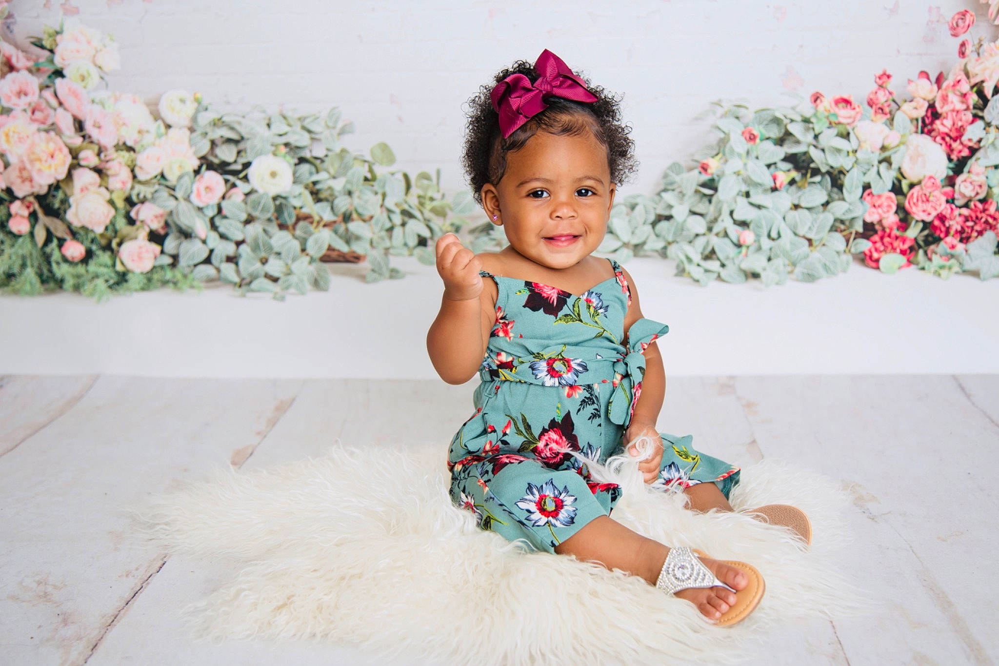 India is registered to the contest to win money with this photo: baby, baby_toddler_clothing, child, child_model, dress, fashion_accessory, hair_accessory, headband, headgear, headpiece, joy, pattern, person, photograph, photography, pink, sitting, skin, smile, textile