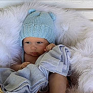 Maxim is registered to the contest to win money with this photo: baby, baby_face, basket, blanket, blue_blanket, blue_hat, child, cozy, cute, fur, indoor, infant, knit_hat, newborn, portrait, resting, sleepy, soft_texture, warm, white_fur