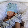 baby, baby_face, basket, blanket, blue_blanket, blue_hat, child, cozy, cute, fur, indoor, infant, knit_hat, newborn, portrait, resting, sleepy, soft_texture, warm, white_fur