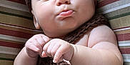 Maxim is registered to the contest to win money with this photo: baby, brown, button, child, closeup, cozy, cushion, cute, hand, indoors, infant, knitted_clothing, newborn, peaceful, portrait, pout, resting, sleeping, soft_skin, striped