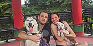 Lilliana May joined the competition — help win amazing prizes! man, woman, husky, puppy, dog, pet, outdoor, pavilion, red_pillar, bench, smiling, happy, sitting, casual_clothing, nature, greenery, tongue_out, playful, young_adult, leash
