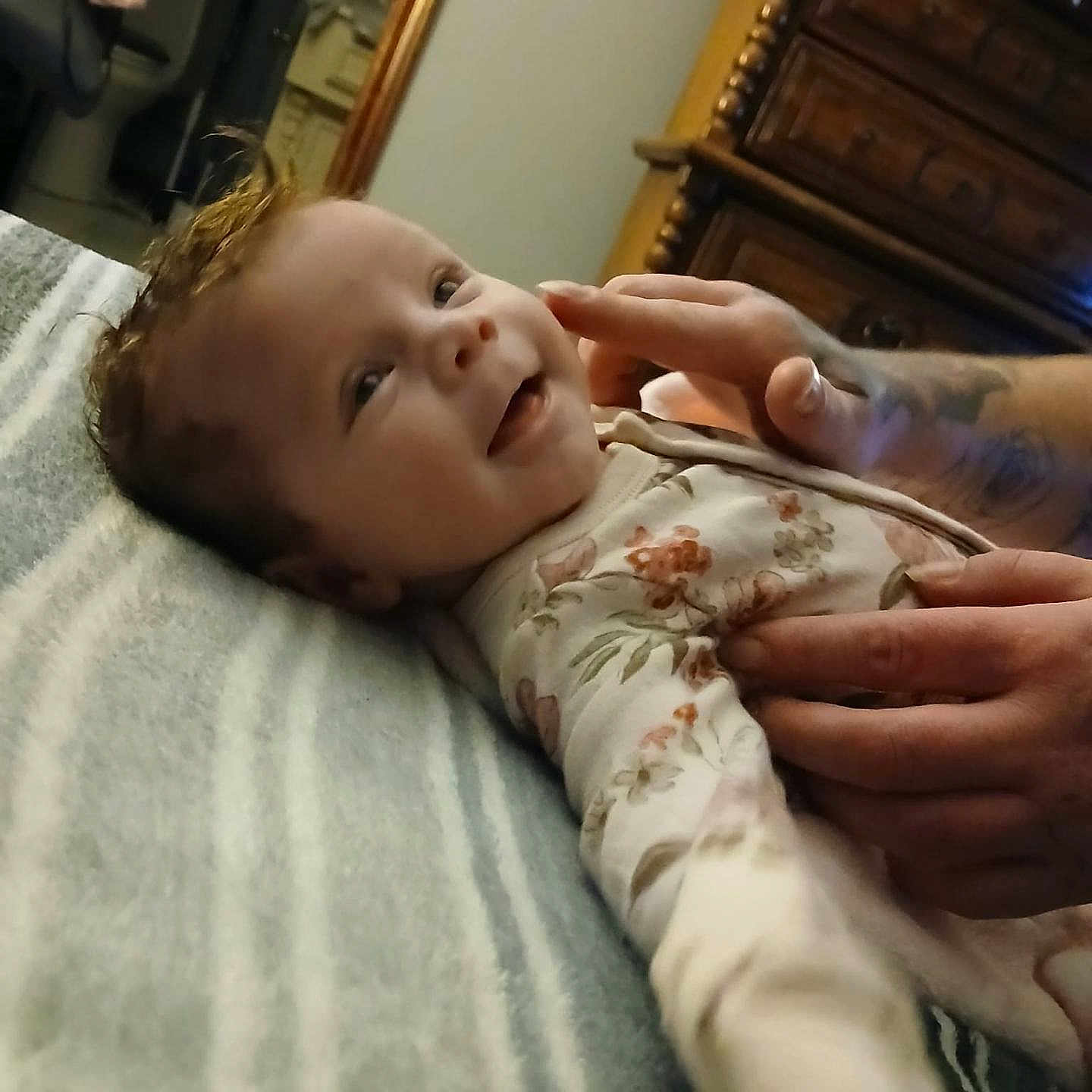 Starrlynn joined the competition — help win amazing prizes! baby, bedroom, blanket, child, clothing, cozy, cute, drawer, floral, furniture, hands, happy, infant, person, portrait, smiling, soft, striped, tattoo, wood