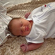 Zoey joined the competition — help win amazing prizes! newborn, baby, sleeping, infant, portrait, face, closed_eyes, onesie, swaddled, blanket, bedding, tiny_hands, tiny_feet, peaceful, indoors, soft_texture, white_clothing, lying_down, nursery, closeup