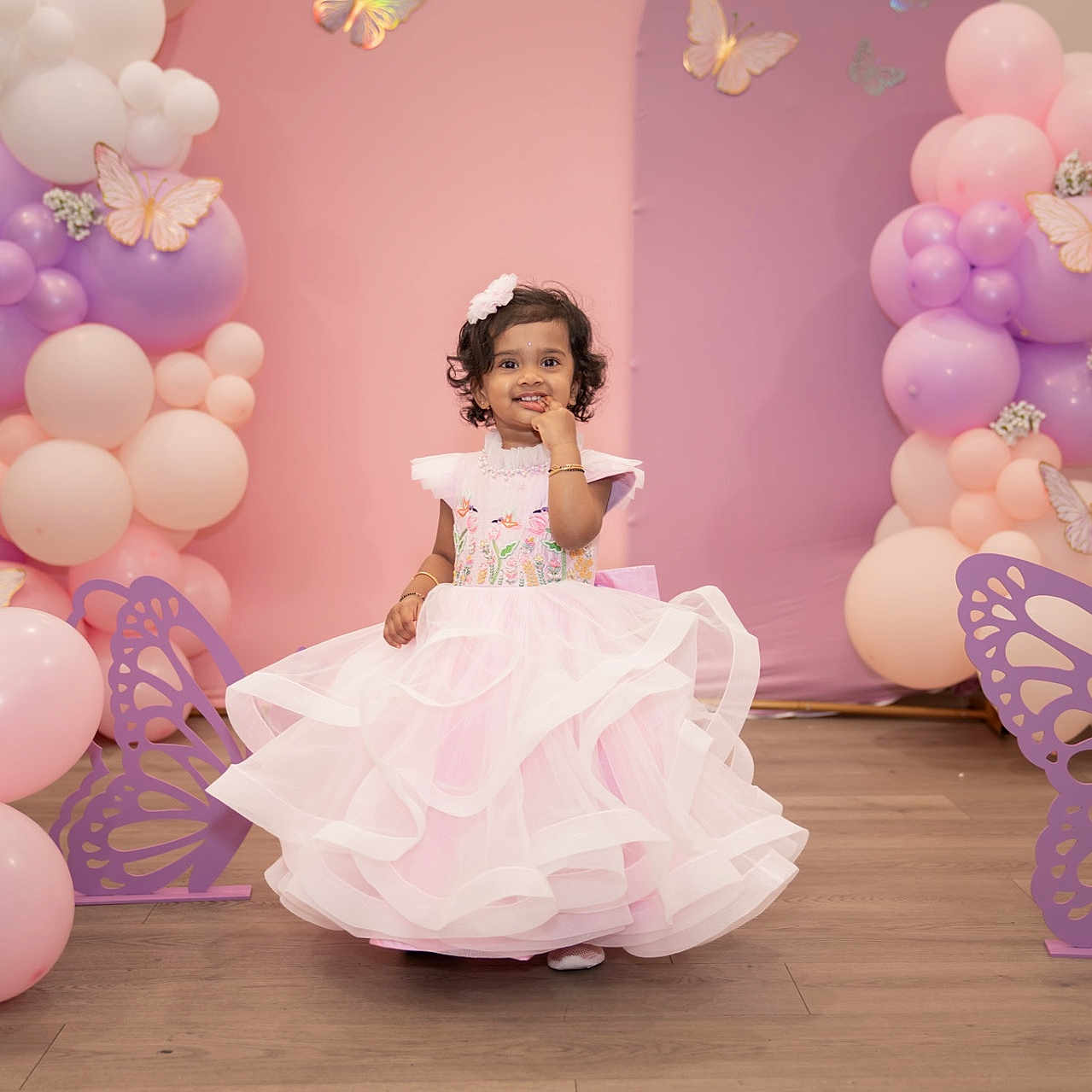Nirvy joined the competition — help win amazing prizes! toddler, girl, dress, pink, balloons, butterfly, party, decoration, curly_hair, floor, indoor, smile, child, celebration, cute, happy, event, festive, colorful, portrait