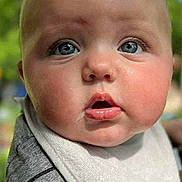 Axl Byrd joined the competition — help win amazing prizes! baby, close_up, face, blue_eyes, bib, chubby_cheeks, expression, outdoor, greenery, soft_focus, infant, cute, portrait, child, apparel, striped_shirt, skin, person, head, young