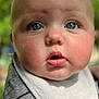 baby, close_up, face, blue_eyes, bib, chubby_cheeks, expression, outdoor, greenery, soft_focus, infant, cute, portrait, child, apparel, striped_shirt, skin, person, head, young