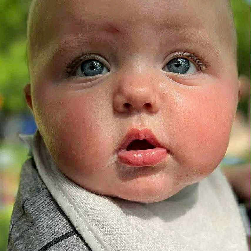 Axl Byrd joined the competition — help win amazing prizes! apparel, baby, bib, blue_eyes, child, chubby_cheeks, close_up, cute, expression, face, greenery, head, infant, outdoor, person, portrait, skin, soft_focus, striped_shirt, young