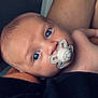 baby, infant, pacifier, blue_eyes, close_up, skin, arm, resting, human, child, newborn, cute, face, expression, portrait, comfort, sleepy, peaceful, holding, tender