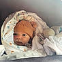 Milo participe au concours pour gagner de l'argent avec cette photo : baby, infant, knit_hat, blanket, paw_prints, plush_toy, soft_toy, wrapped, cute, cozy, warm, face, eyes, child, newborn, indoors, comfort, portrait, sleeping_bag, car_seat
