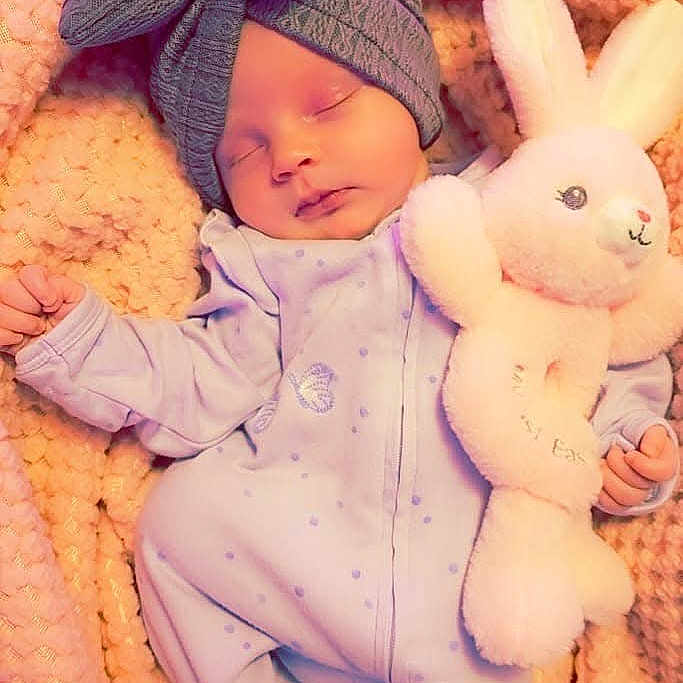 Novalynn joined the competition — help win amazing prizes! baby, beanie, blanket, bonnet, cap, clothing, coat, face, glove, hat, head, newborn, person, photography, portrait, purple, quilt, scarf, sleeping, toy