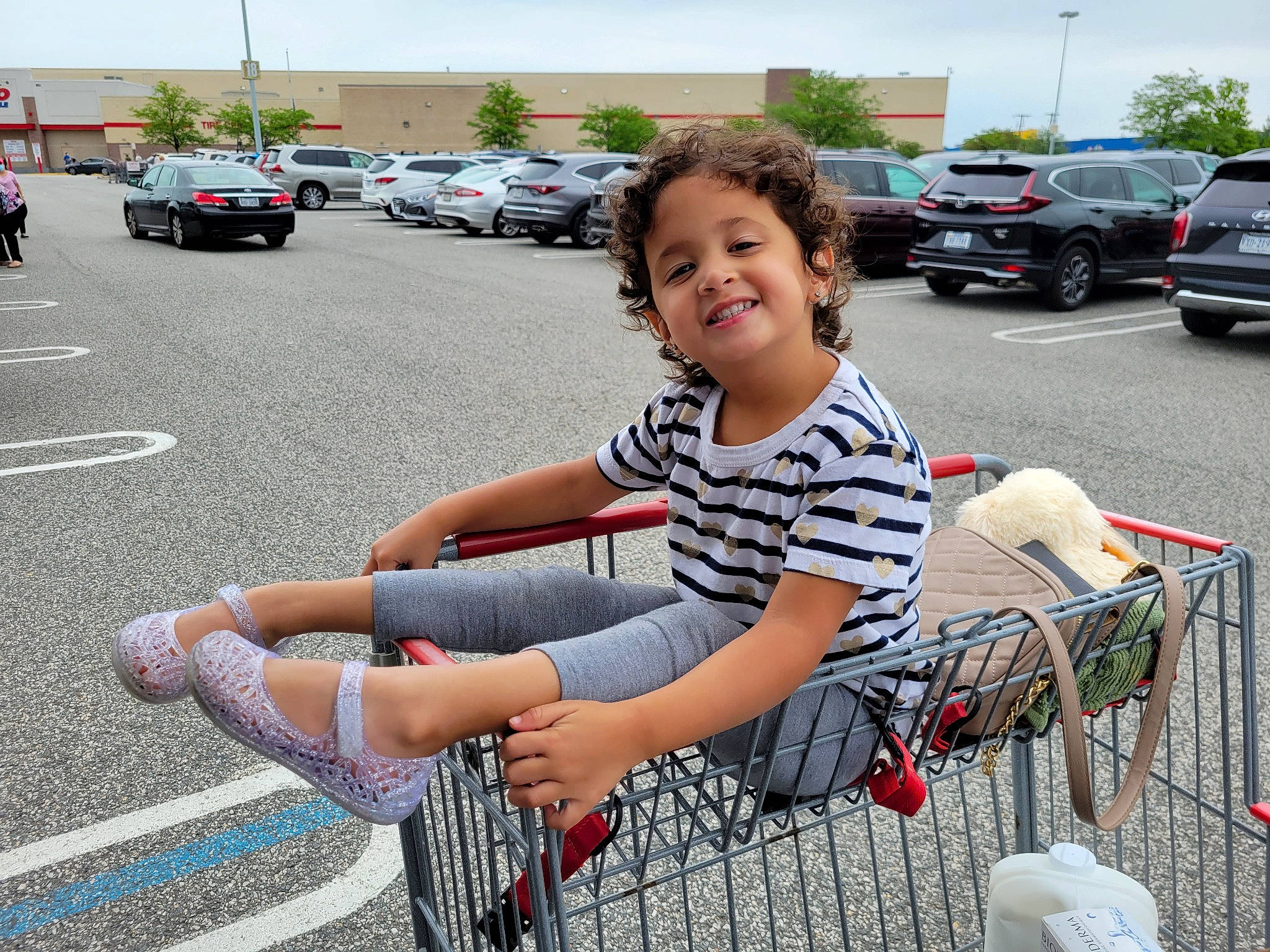 Emilia is registered to the contest to win money with this photo: asphalt, automotive_design, automotive_exterior, automotive_tire, car, fun, joy, land_vehicle, leisure, motor_vehicle, parking, person, public_space, recreation, sidewalk, sky, smile, sneakers, street_fashion, tire