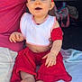 Baylee joined the competition — help win amazing prizes! adult_hand, baby, barefoot, bib, blanket, blue_eyes, car, casual, child, comfort, cute, flower, headband, indoors, infant, parent, person, red_clothing, sitting, smiling
