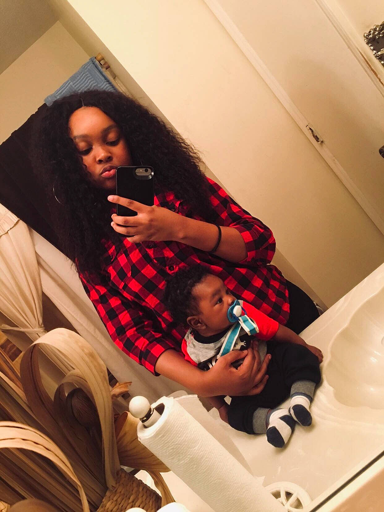 Aiyden is registered to the contest to win money with this photo: black_hair, child, comfort, cool, design, finger, joy, leg, long_hair, pattern, person, photography, plaid, selfie, sitting, tartan, textile, vacation