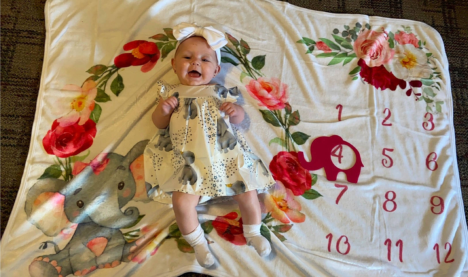 Harper joined the competition — help win amazing prizes! baby, child, cut_flowers, doll, dress, floral_design, flower, flower_arranging, linens, outerwear, pattern, peach, person, petal, pink, plant, product, rose, sleeve, textile