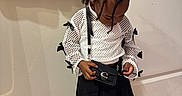 Zayda is registered to the contest to win money with this photo: accessory, black_purse, black_skirt, braided_hair, casual, child, curious, cute, door, fashion, indoor, looking_down, person, pink_trash_bin, standing, towels, white_mesh_top, white_sneakers, wooden_floor, young_child