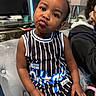 Zayda joined the competition — help win amazing prizes! black_hair, casual, child, computer, couch, cute, desk, expression, furniture, home, indoor, living_room, person, playful, plush, portrait, pout, sitting, striped_clothing, toddler
