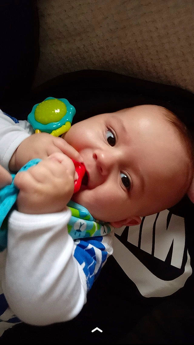 Louie is registered to the contest to win money with this photo: baby, cheek, chin, drinkware, eye, eyebrow, eyelash, facial_expression, finger, gesture, happy, iris, lip, mouth, nose, person, plastic_bottle, product, skin, smile