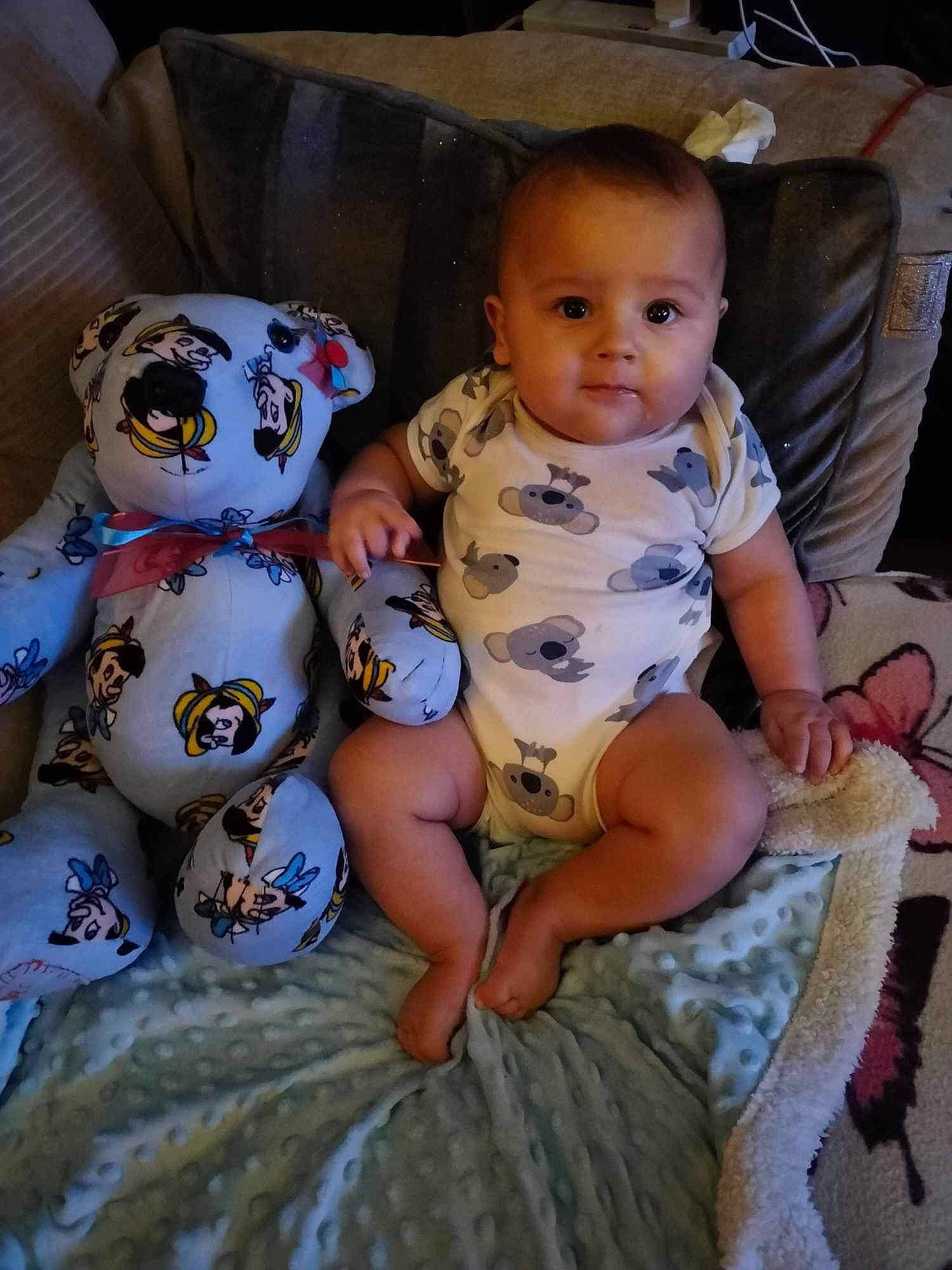Louie is registered to the contest to win money with this photo: baby, baby_products, baby_toddler_clothing, cheek, child, comfort, fun, happy, head, human_body, iris, lap, person, sitting, skin, sleeve, textile, thigh, toddler, toy