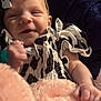 Ava joined the competition — help win amazing prizes! baby, infant, smiling, face, headband, bow, black_and_white, patterned_clothing, blanket, pink_blanket, soft_texture, hand, cute, happy, portrait, indoor, child, newborn, cozy, resting