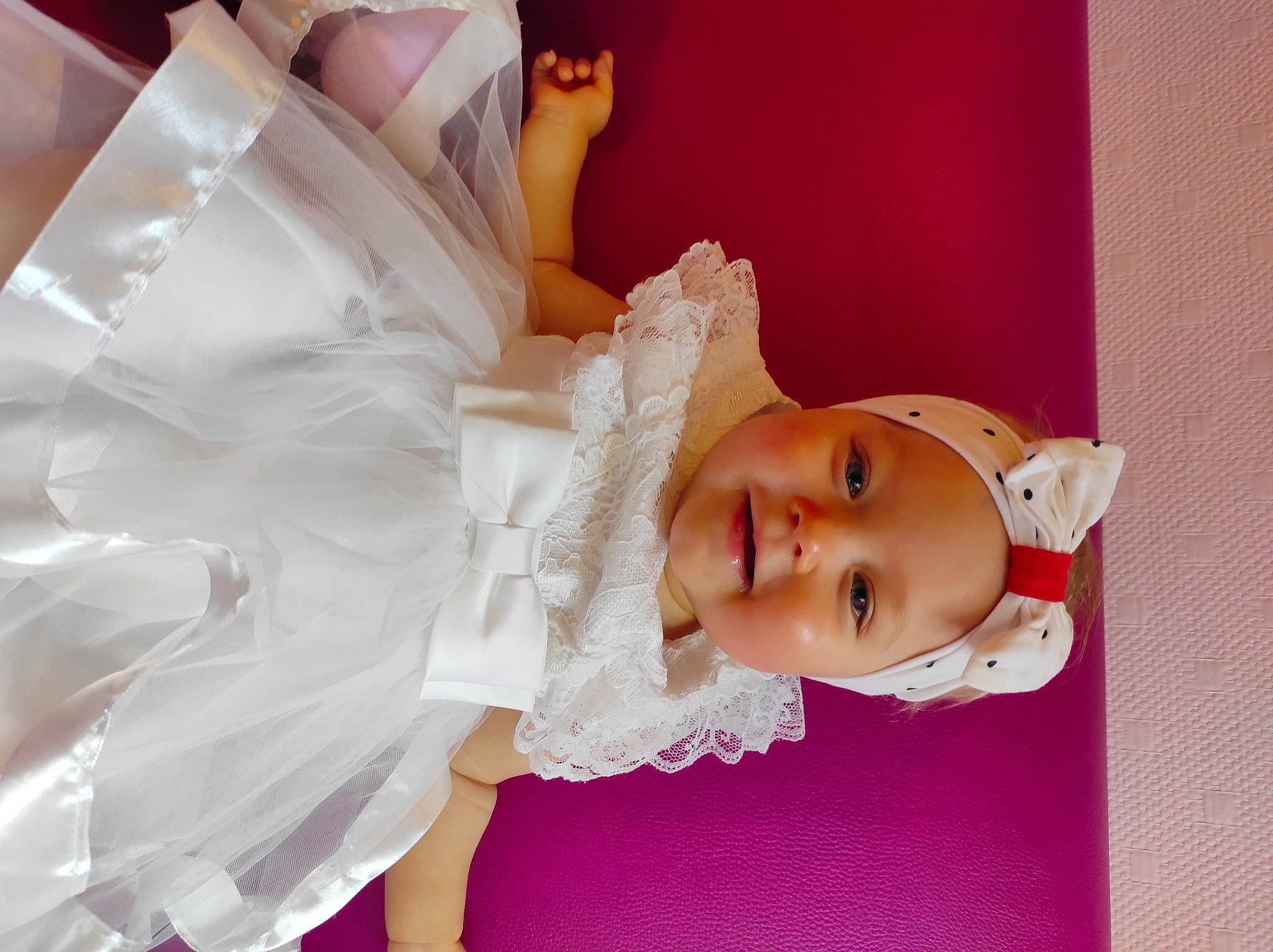 Mila participe au concours pour gagner de l'argent avec cette photo : baby, baby_toddler_clothing, bridal_accessory, dress, embellishment, event, eyelash, fashion_accessory, fashion_design, hair_accessory, hairstyle, happy, headgear, headpiece, headwear, human_body, person, pink, skin, smile