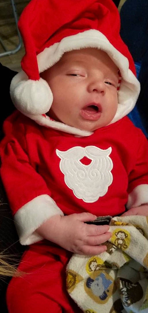 Forest is registered to the contest to win money with this photo: boy, cheek, child, christmas, facial_expression, fictional_character, fun, happiness, headwear, holiday, infant, lap, person, product, red, santa_claus, skin, smile, toddler