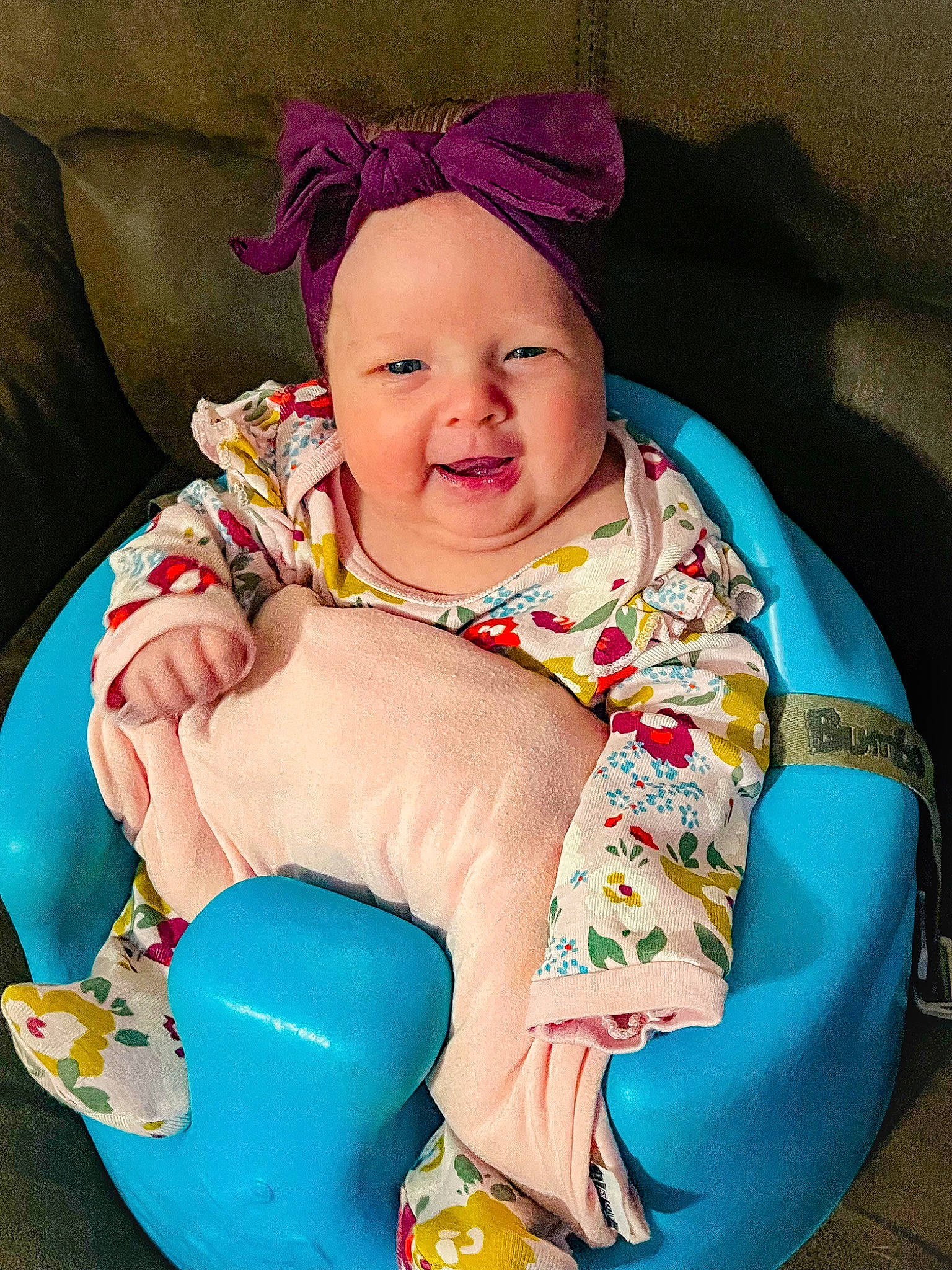 Elle is registered to the contest to win money with this photo: arm, baby, baby_laughing, baby_products, baby_toddler_clothing, cheek, child, comfort, event, fashion_accessory, finger, fun, happy, head, headwear, magenta, person, pink, sitting, skin