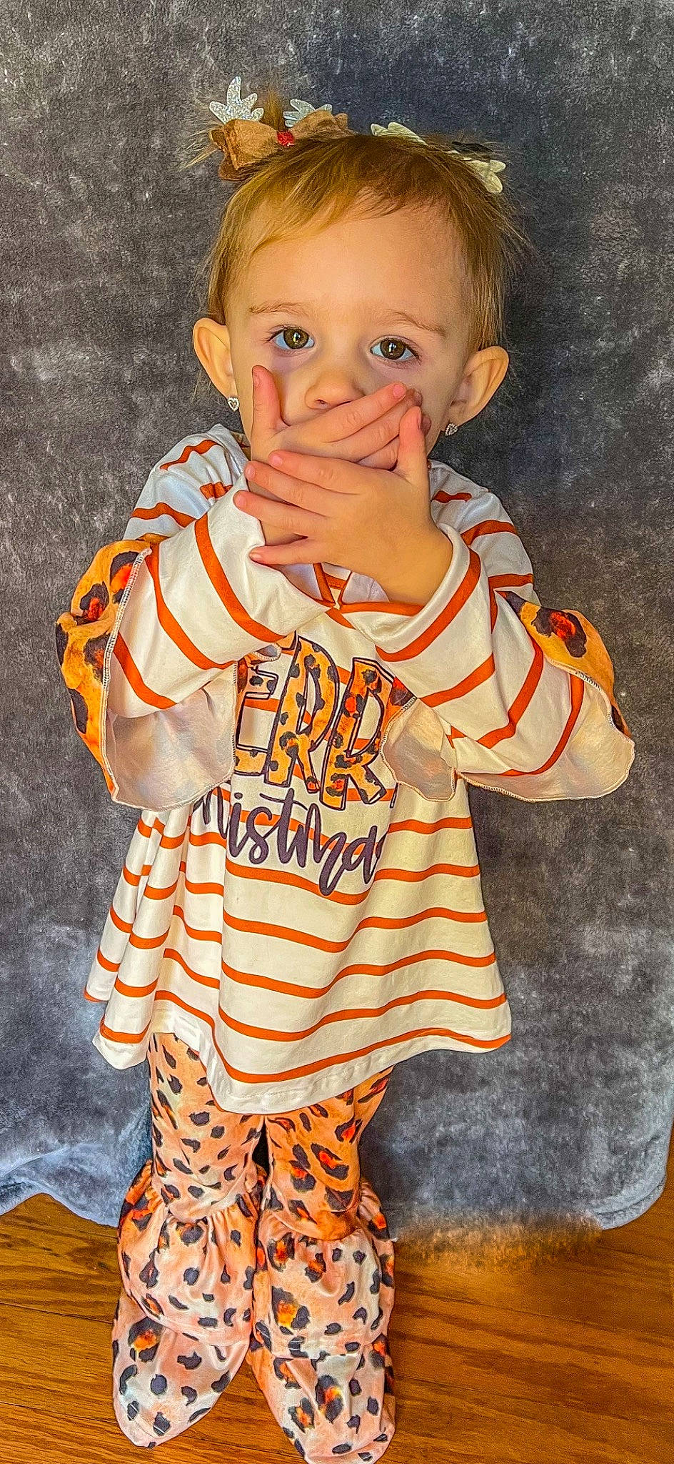 Oaklynn is registered to the contest to win money with this photo: baby_toddler_clothing, cheek, child, chin, eye, gesture, hair, happy, head, human, jersey, long_sleeved_t_shirt, nose, orange, outerwear, pattern, person, sleeve, t_shirt, thumb