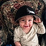 Adahlia joined the competition — help win amazing prizes! toddler, child, smile, cap, hat, couch, floral_pattern, indoor, sitting, person, clothing, face, hand, happy, cute, young_child, portrait, blanket, fabric, home