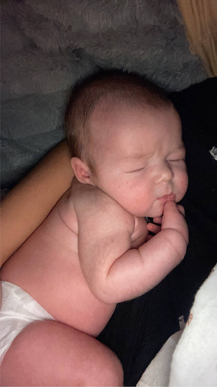 Braxton is registered to the contest to win money with this photo: arm, baby, cheek, chin, comfort, ear, eye, eyebrow, face, finger, gesture, head, human_body, iris, lip, mouth, nose, person, skin, stomach