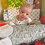 baby, child, infant, blanket, christmas_tree, christmas_decorations, presents, ornaments, santa_stocking, holiday, festive, smiling, face, portrait, indoor, cute, soft_texture, red, white, cozy