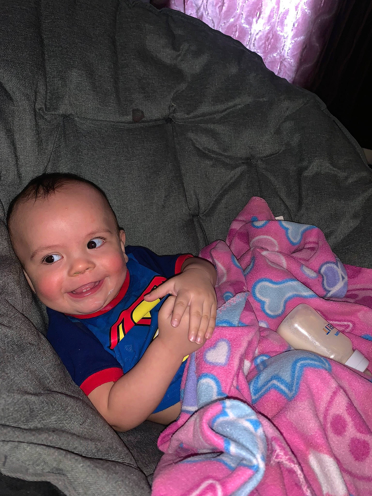 Jaxon is registered to the contest to win money with this photo: arm, baby, baby_toddler_clothing, cheek, child, comfort, couch, finger, flash_photography, fun, happy, iris, joy, lap, magenta, nose, person, pink, purple, smile