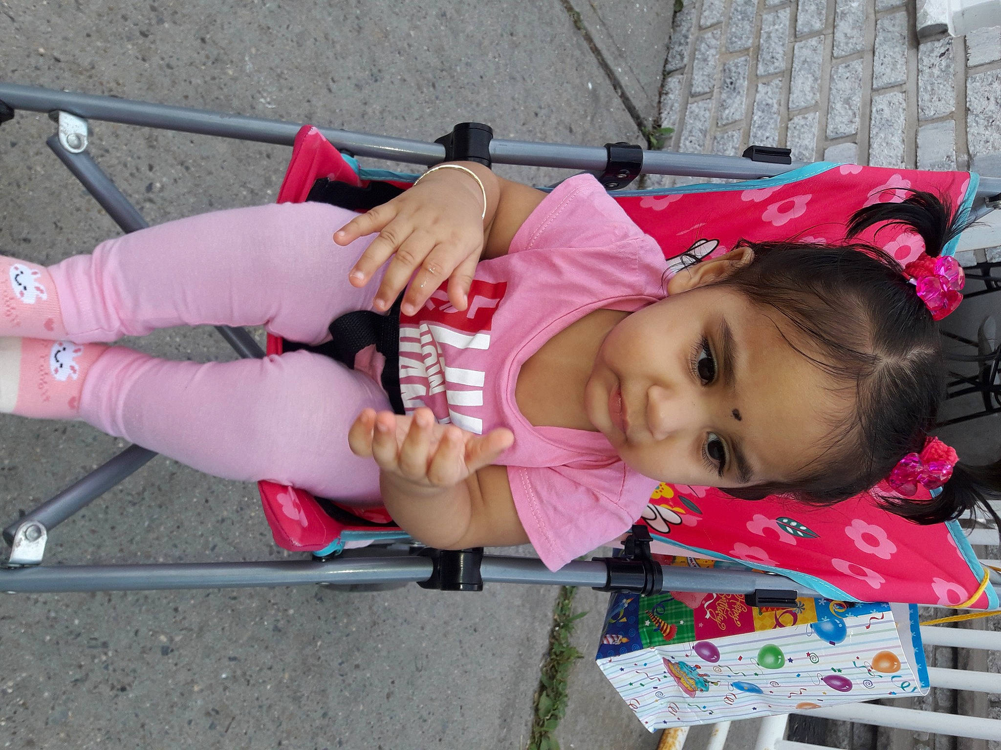 Annabella is registered to the contest to win money with this photo: baby, baby_products, baby_toddler_clothing, cheek, child, city, fun, hat, human_leg, leisure, magenta, person, pink, recreation, shorts, skin, sock, thigh, toddler, tree