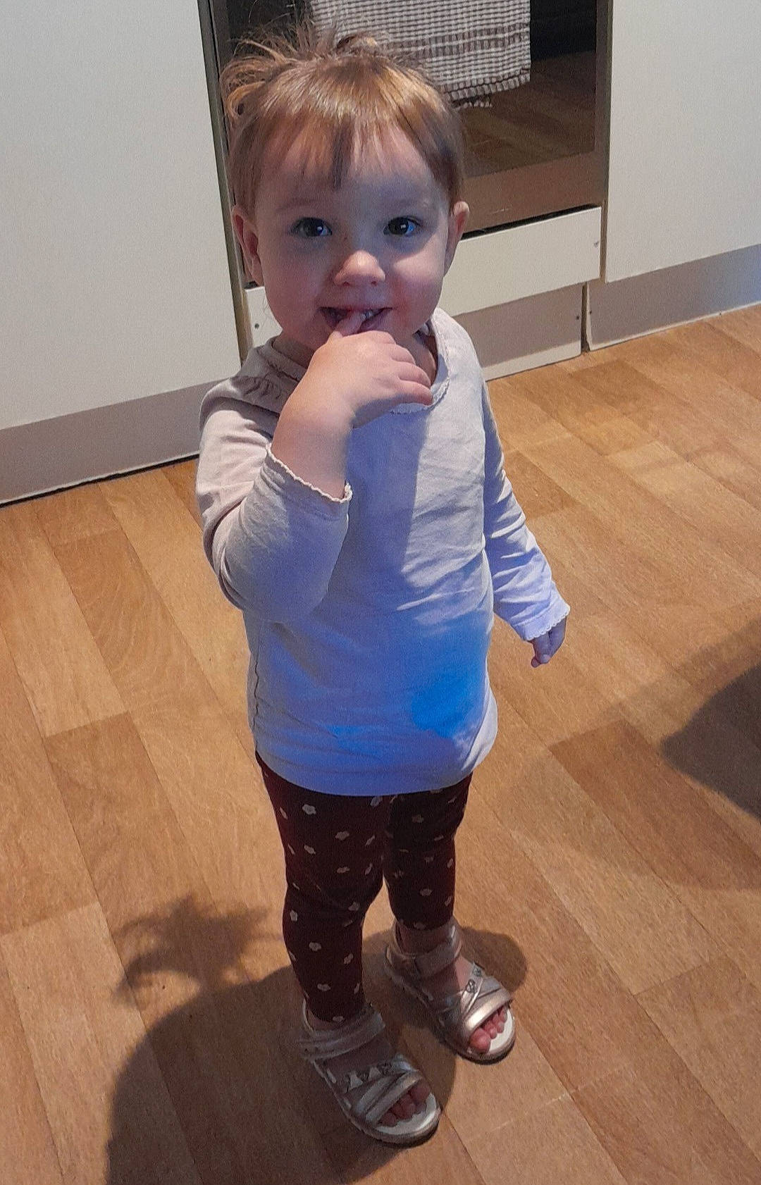 Eleanor participe au concours pour gagner de l'argent avec cette photo : baby, baby_toddler_clothing, cheek, electric_blue, eye, floor, flooring, fun, hardwood, head, human_leg, joint, knee, nose, person, sleeve, t_shirt, thigh, toddler, trunk