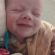 Adam participe au concours pour gagner de l'argent avec cette photo : baby, blanket, brown_clothing, cheeks, child, closeup, cozy, cute, face, hand, head, infant, newborn, pacifier, peaceful, portrait, resting, skin, sleeping, smiling