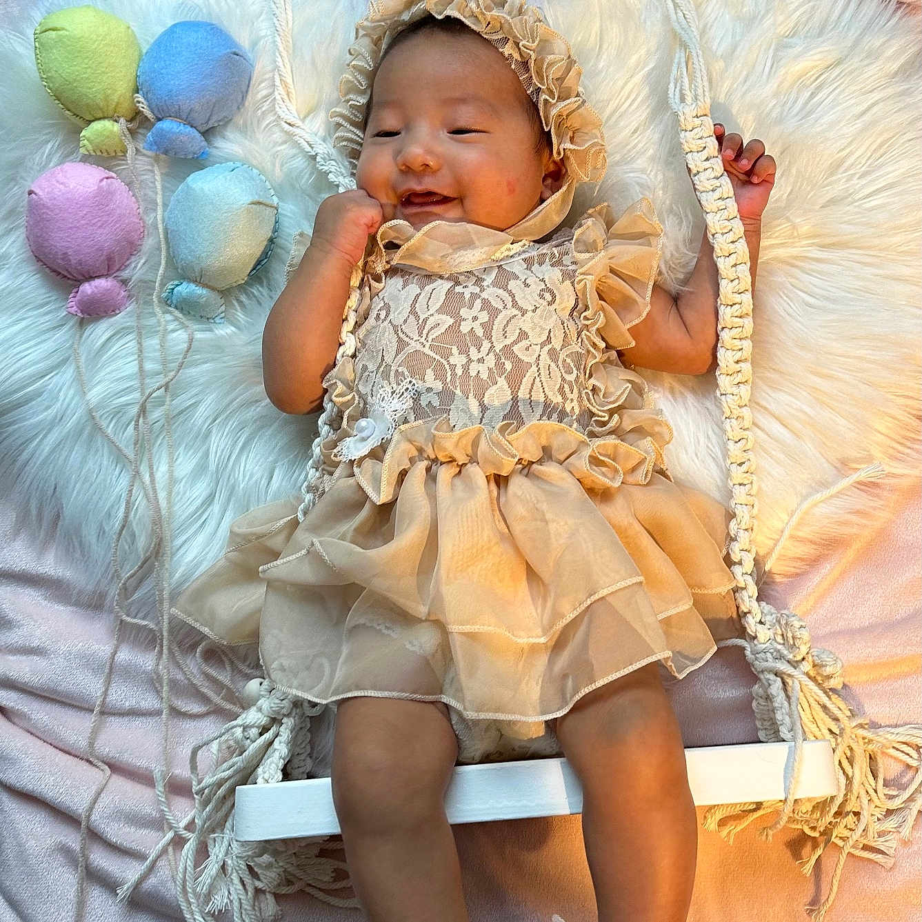 Mylanie joined the competition — help win amazing prizes! baby, bonnet, child, cute, decor, dress, fluffy_rug, footwear, happy, indoor, infant, lace, pastel_colors, pearl_bracelets, plush_balloons, portrait, rope, smiling, soft_lighting, swing