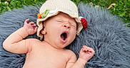 Dale joined the competition — help win amazing prizes! baby, yawn, crocheted_hat, blanket, outdoor, grass, greenery, infant, cute, sleepy, nature, soft_texture, relaxation, child, newborn, skin, portrait, headwear, lying_down, peaceful